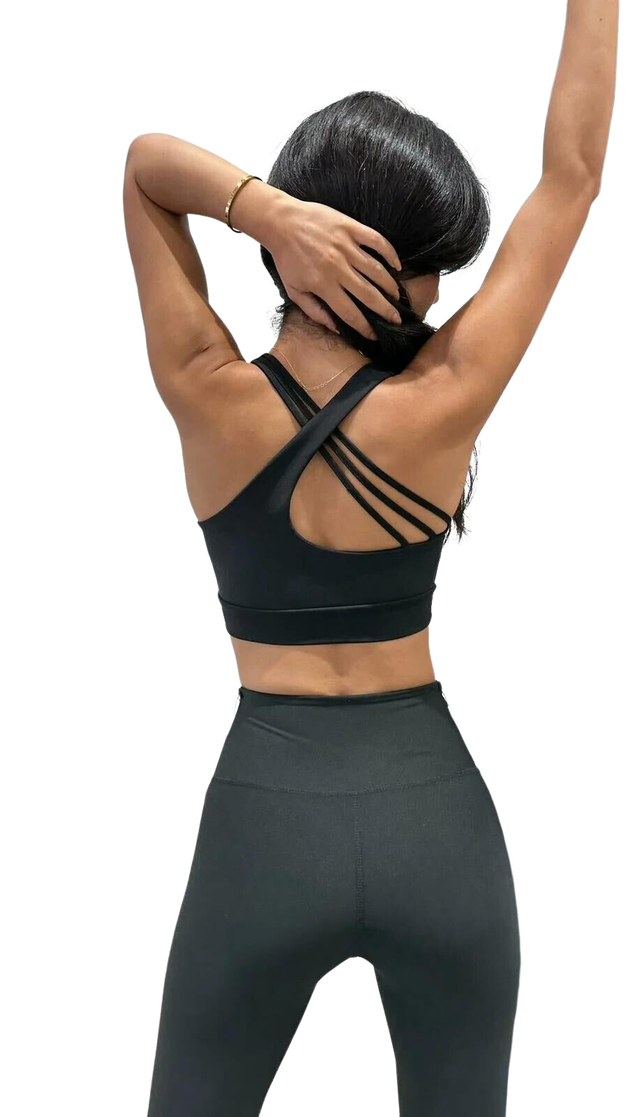 Frau trägt Lismina 396 Bron Sport Bra in Schwarz, Arme gehoben, zeigt Rücken mit überkreuzten Trägern. Weißer Hintergrund.